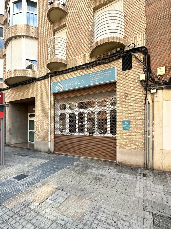 Fachada de Lacasa Multiespacio en la calle Doctor Lluch, con el cartel y la celosía blanca